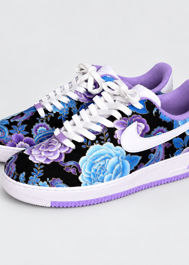Blue and purple floral custom sneakers on a light gray studio background