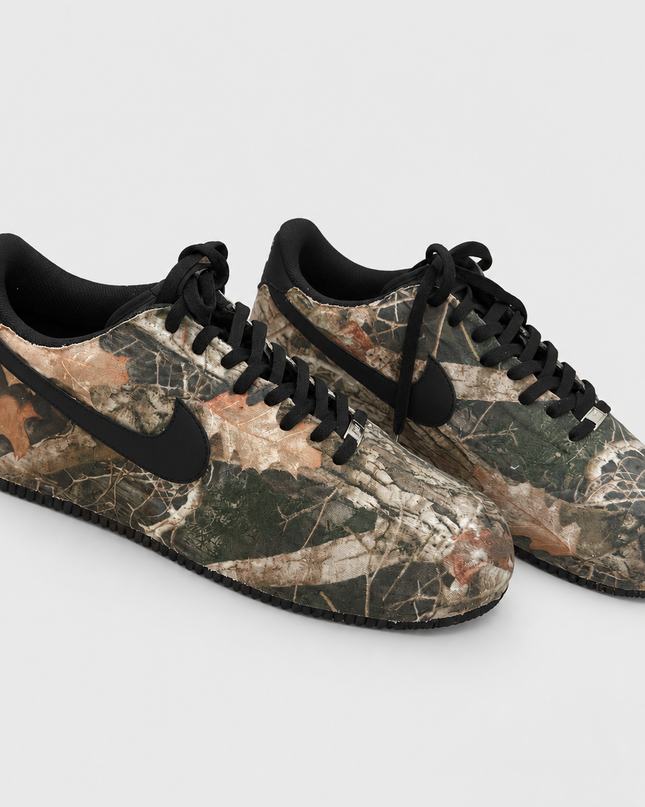 Camo custom sneakers on a light gray studio background